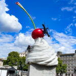 Sculpture of whipped cream topped with a cherry, fly and a drone by Heather Phillipson on the Fourth Plinth, Trafalgar Square, London.