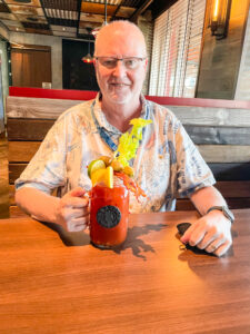 John and his colorful Bloody Mary in a Pig and Anchor Mug.